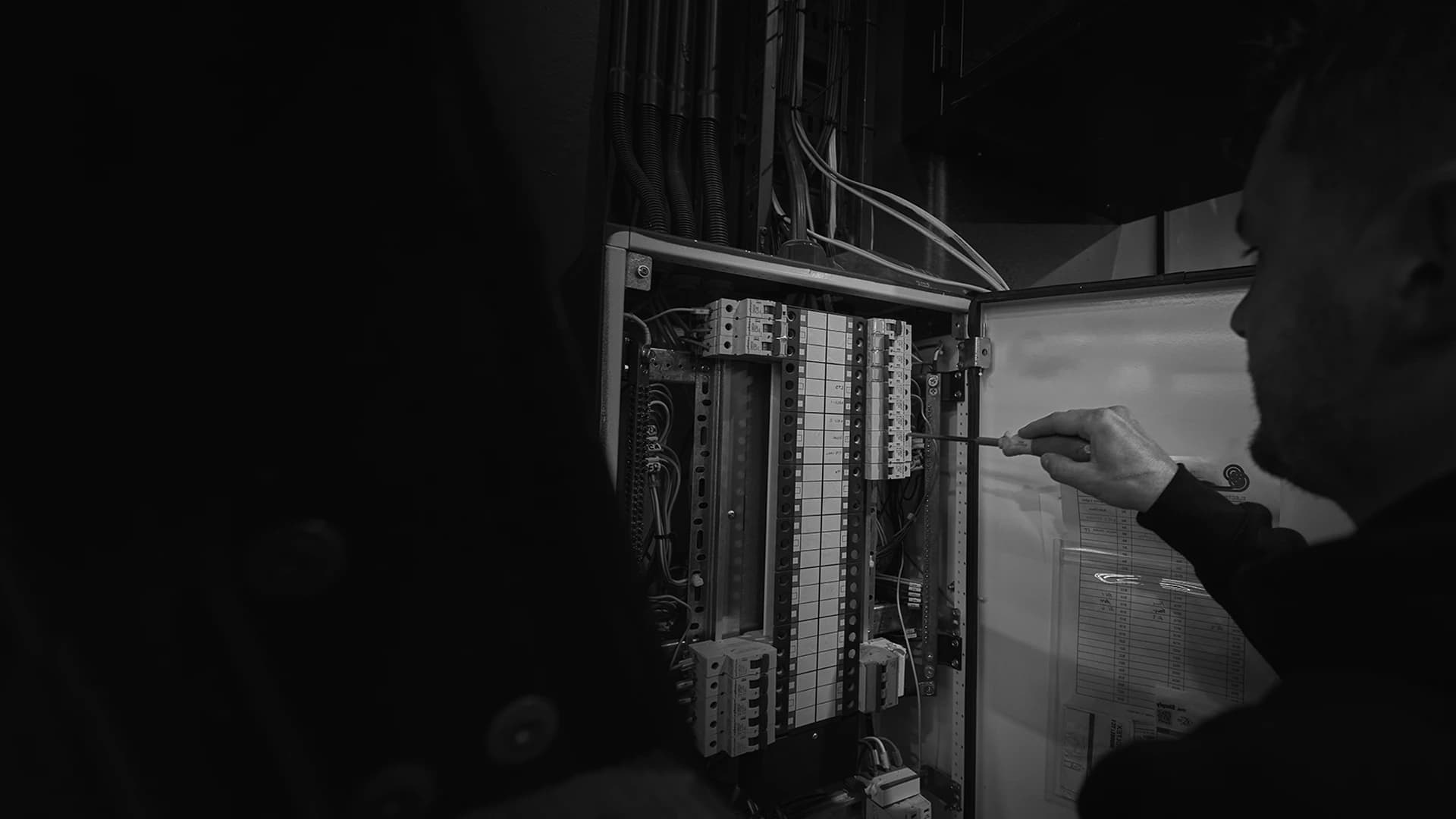 Electric Avenue electrician working inside a switchboard in Tauranga